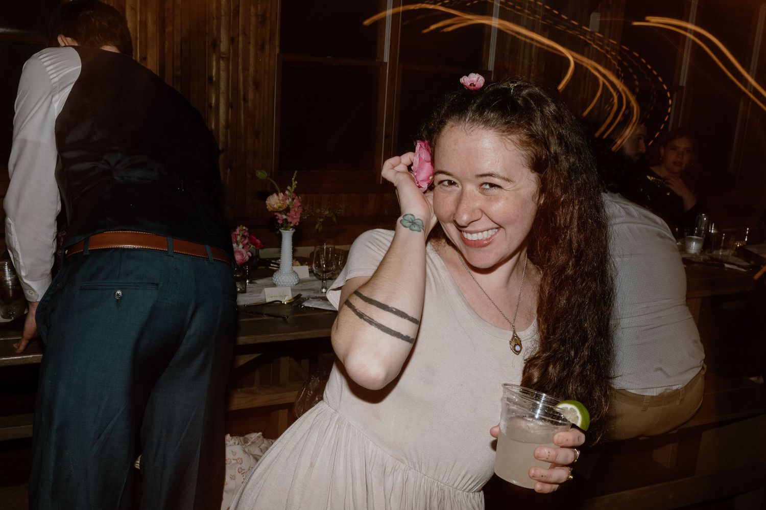 Guest enjoying themselves at dimly lit wedding reception party.