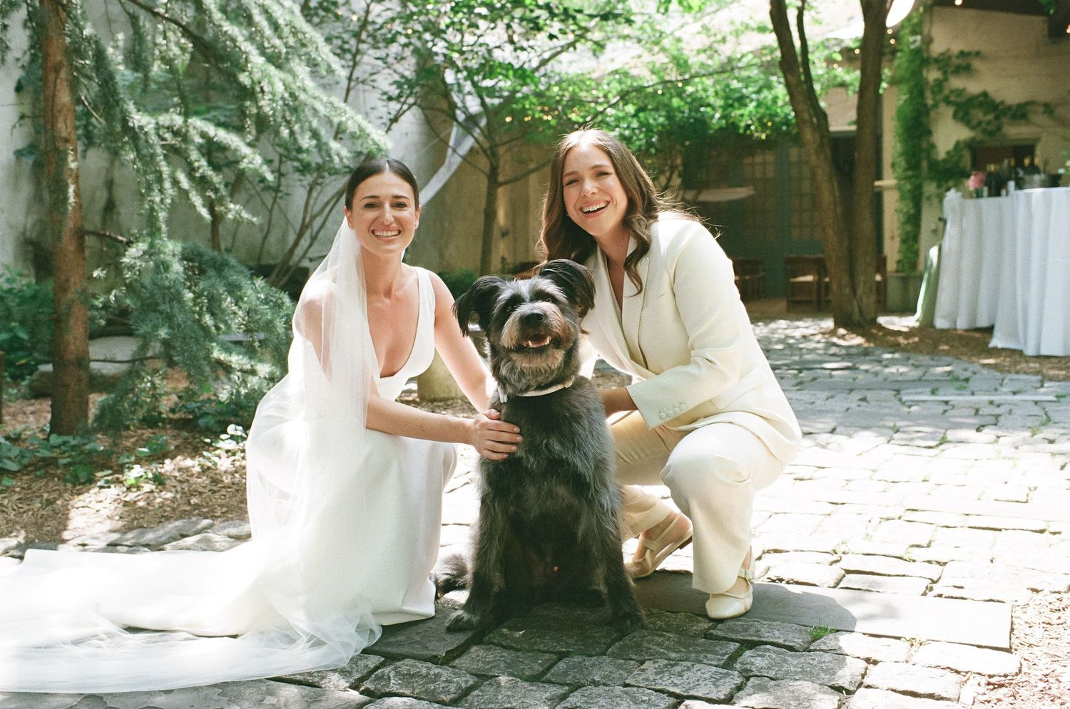 Wedding preparations on stone patio surrounded by lush greenery and natural light.