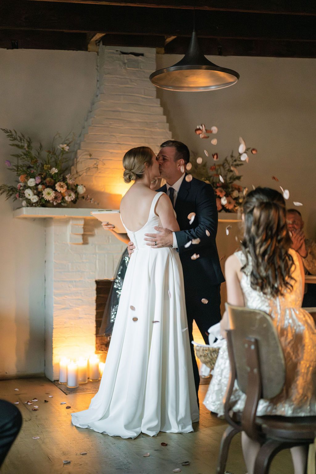 Wedding couple dancing together in a rustic venue with white brick walls and pendant lighting Fadensonnon in Baltimore