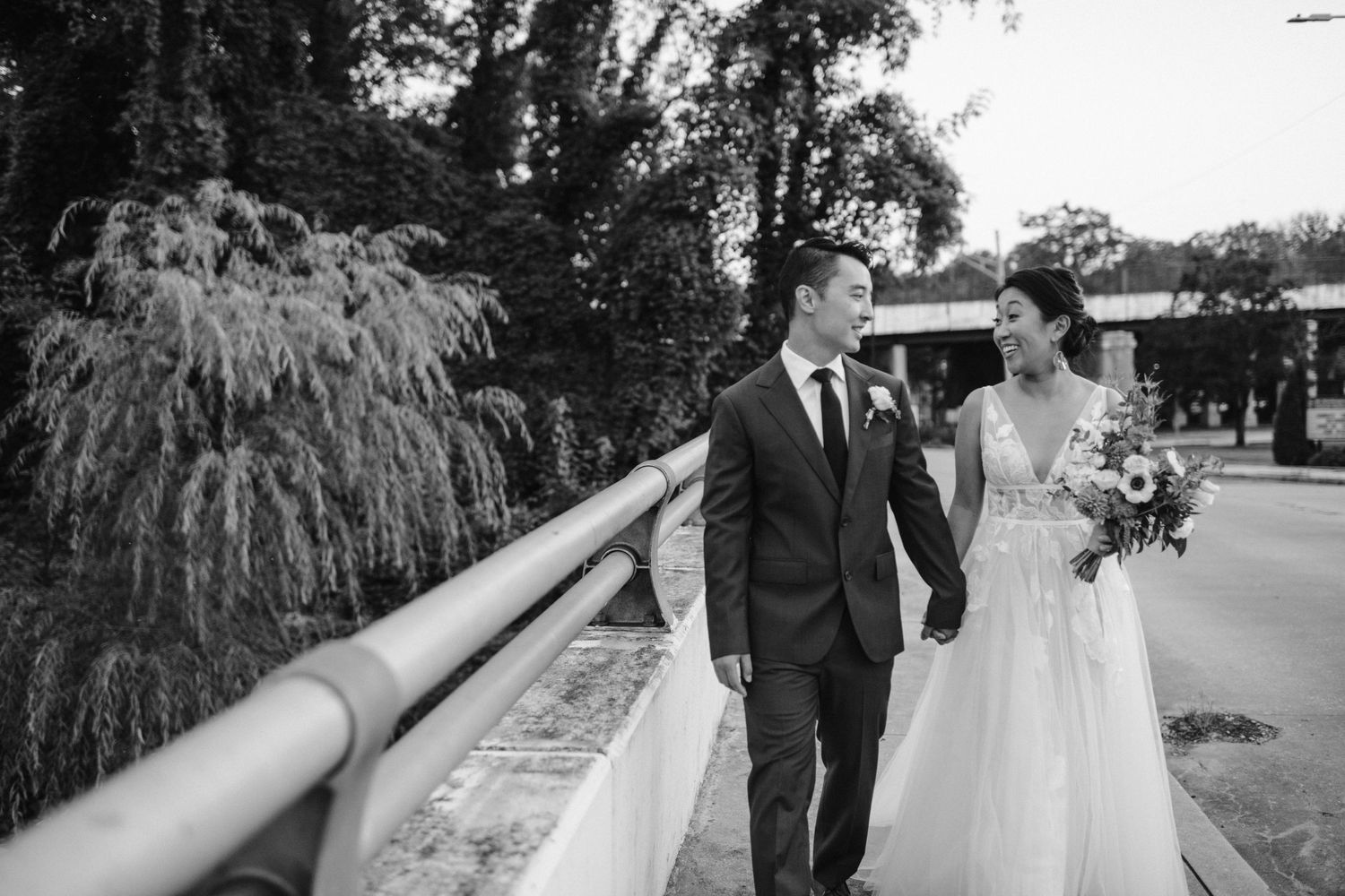 bride and groom cross bridge back to the the mt washington mill dye house