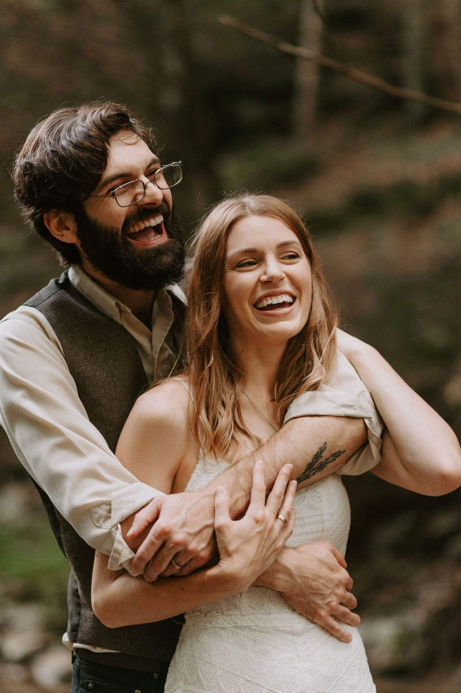 Joyful embrace captured in natural forest setting.