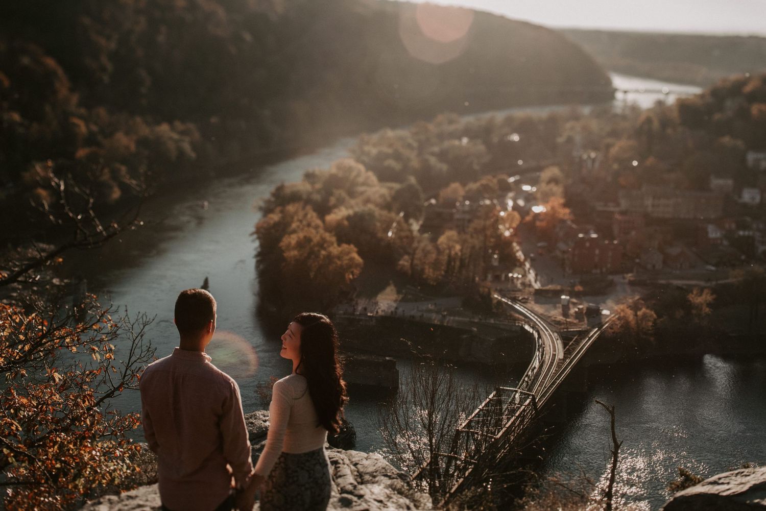 A scenic overlook of a winding river valley during golden hour.