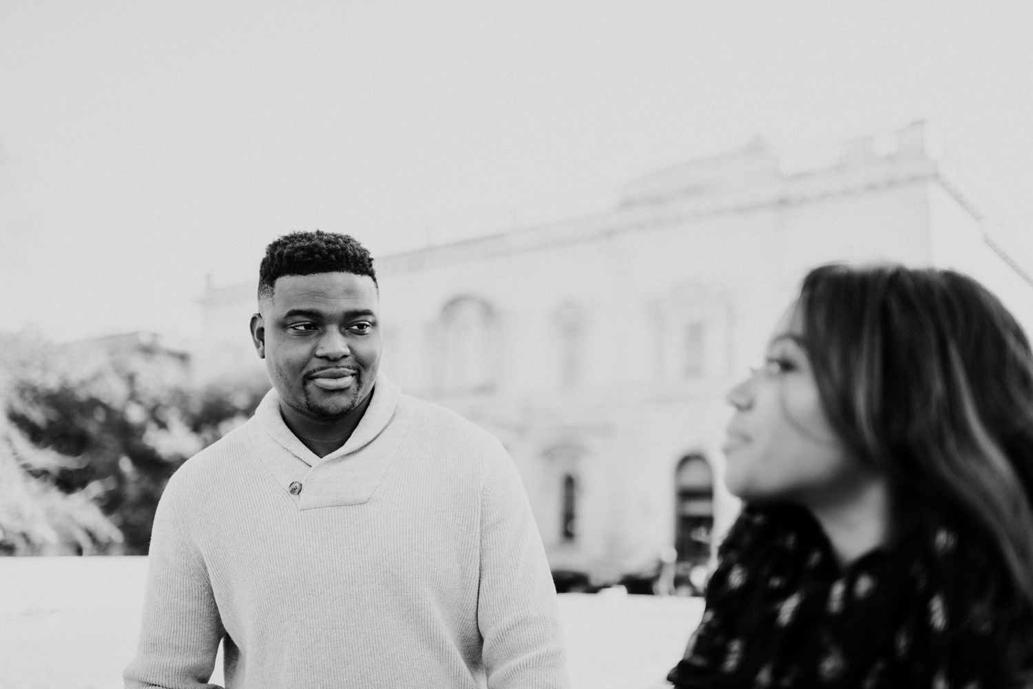 A black and white candid portrait of a couple enjoying a moment together.