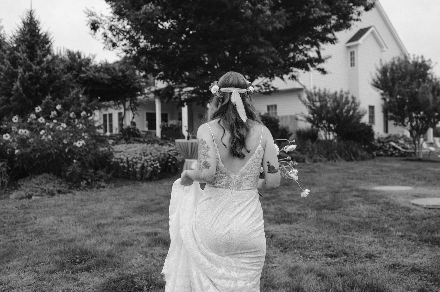bride walking back to house black and white wedding photos backyard