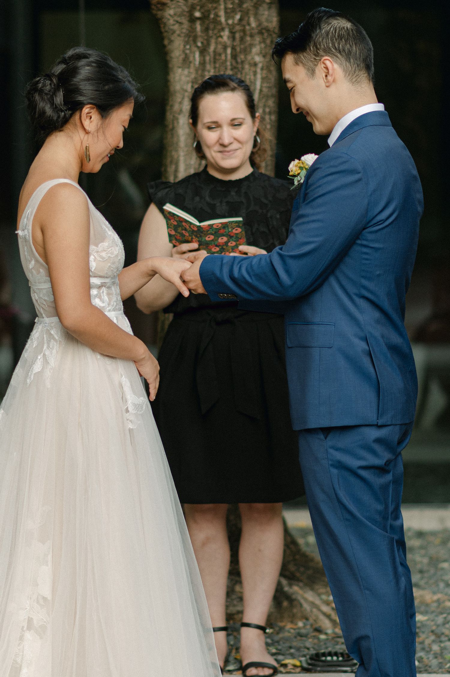 bride and groom exchange wedding rings