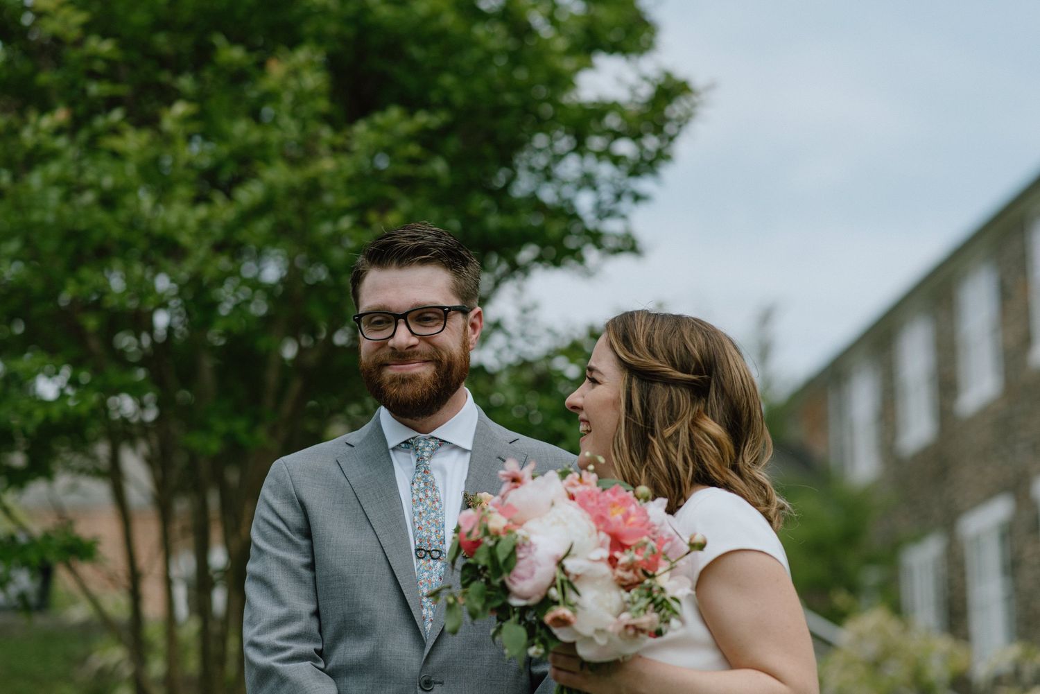Couple sharing intimate moment during outdoor spring wedding.