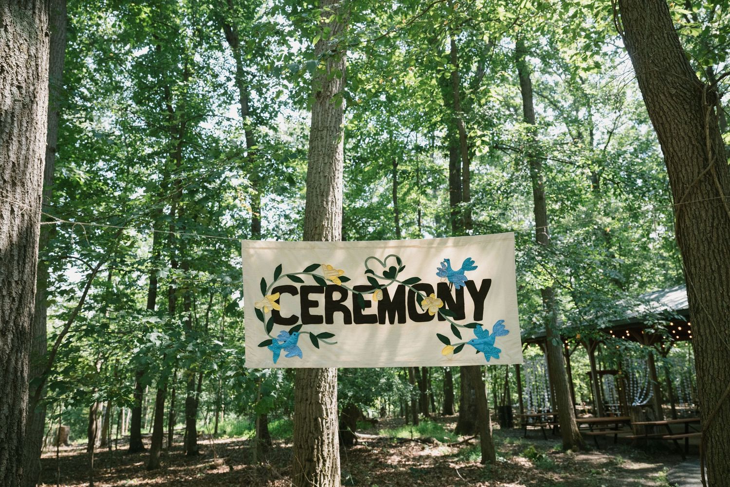 wedding ceremony sign at summer camp wedding at camp hidden valley