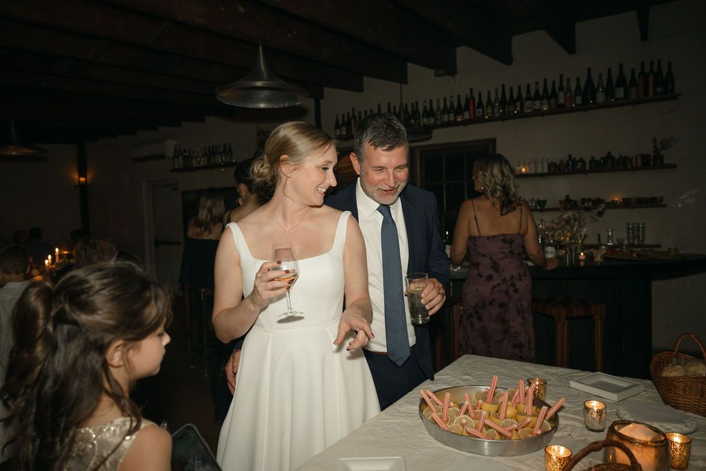 Guests gathered around a festive table with food and drinks at an indoor celebration Fadensonnon in Baltimore