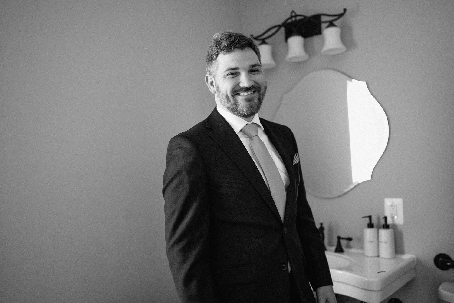 groom smiles at camera