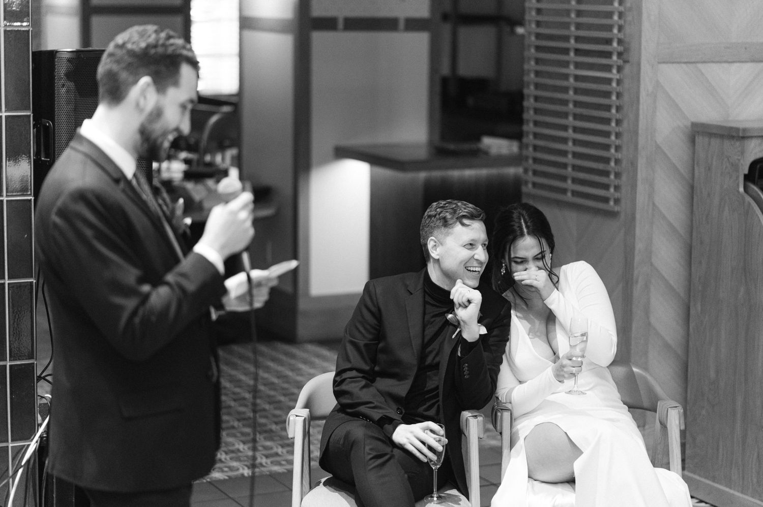A photographer captures wedding moments in black and white.