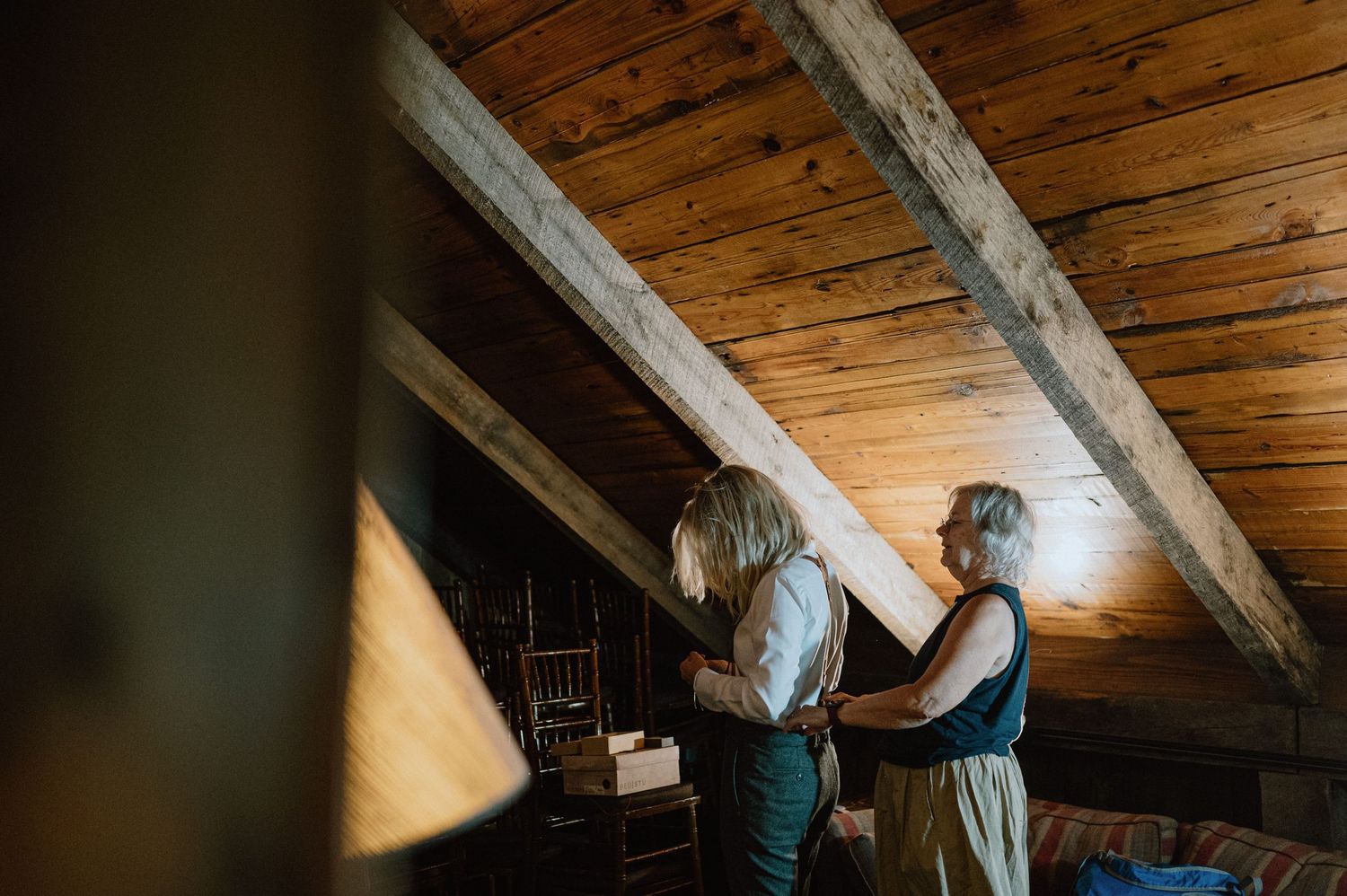 mother helping bride put on her suspenders nontraditional wedding