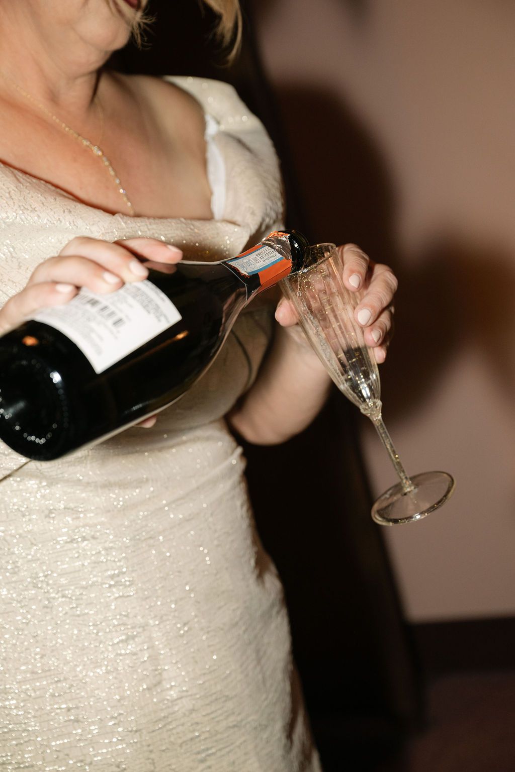 A sequence of images showing champagne being poured into a glass against a dark background.