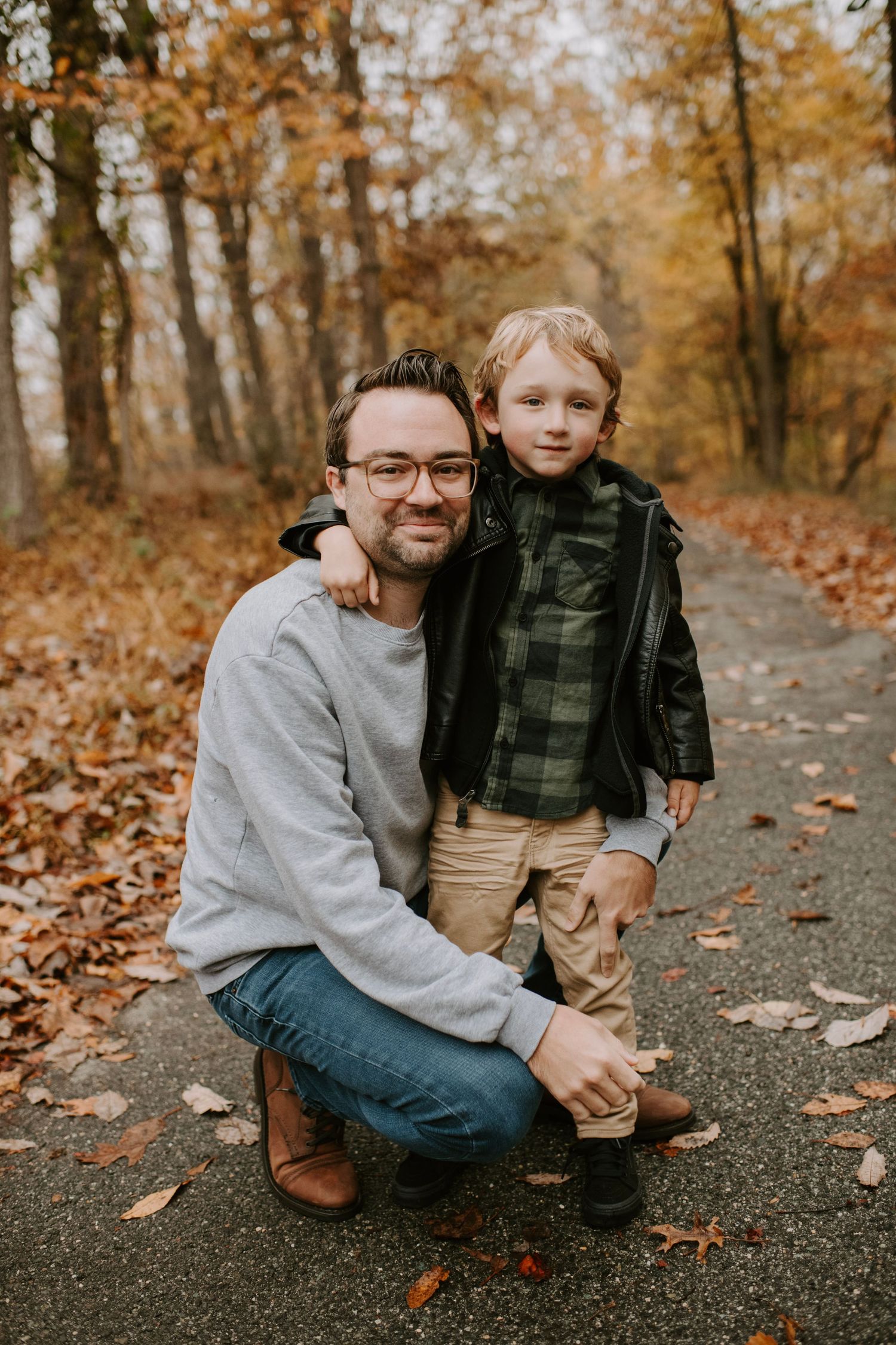 Heartwarming autumn moment captured on a forest trail with fallen leaves.