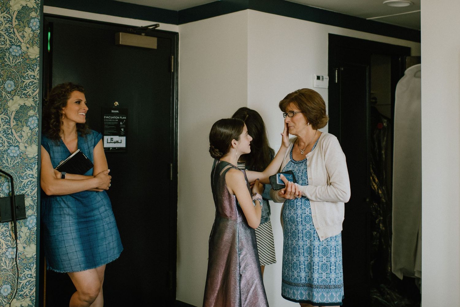 mom crying while bride gets ready