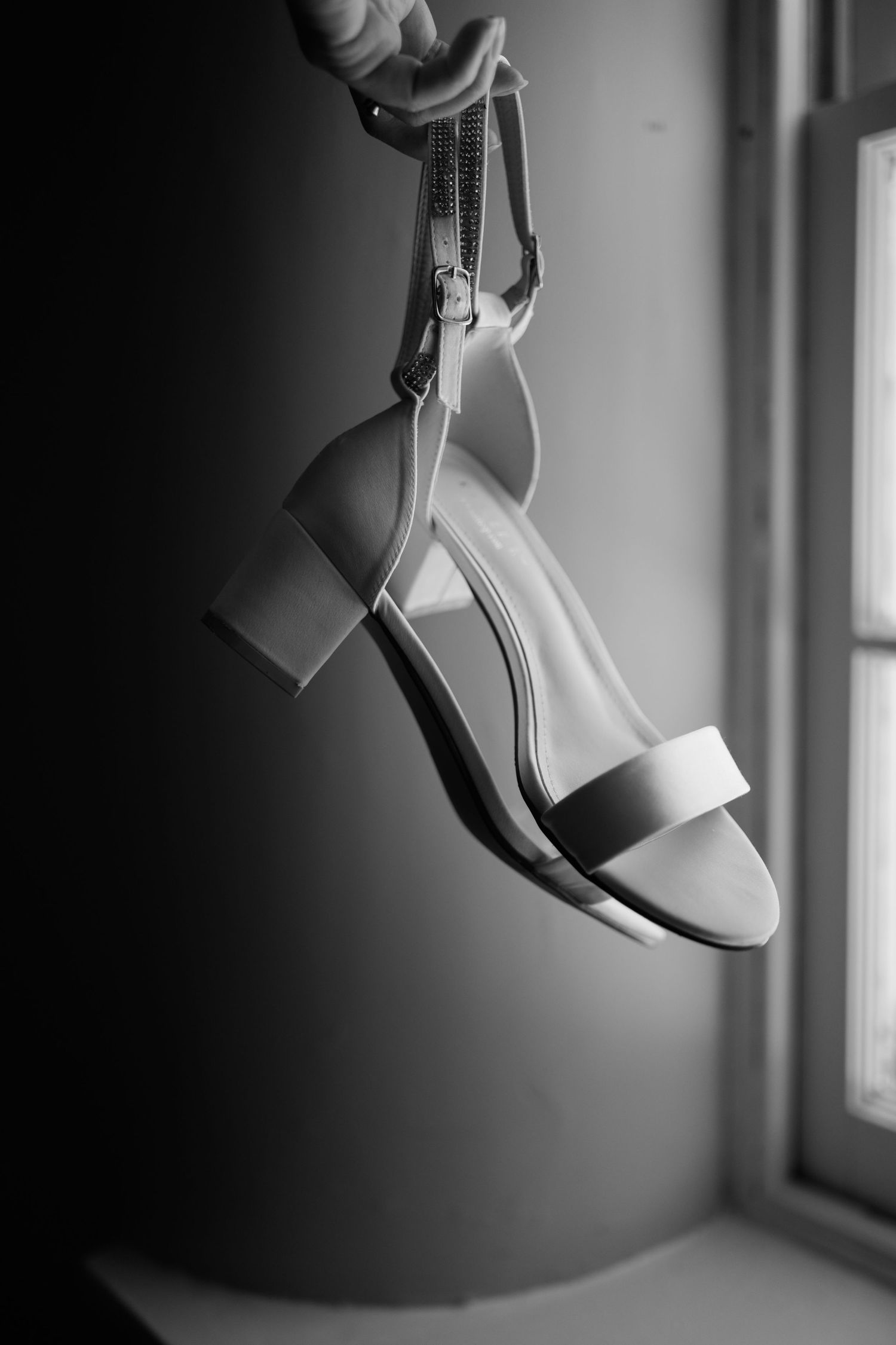 brides shoes held by windo