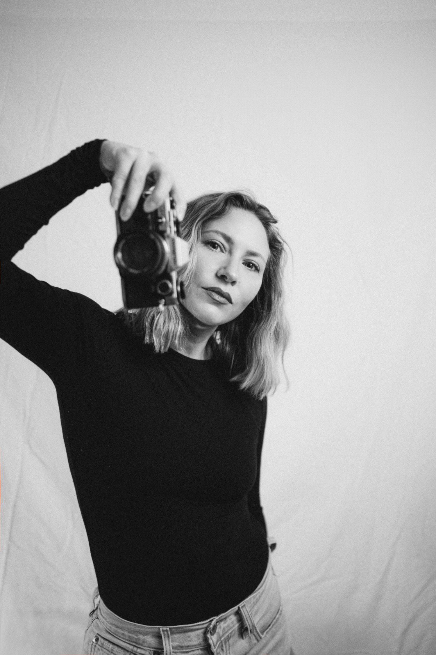 Artistic black and white portrait series showing movement in front of a white backdrop.