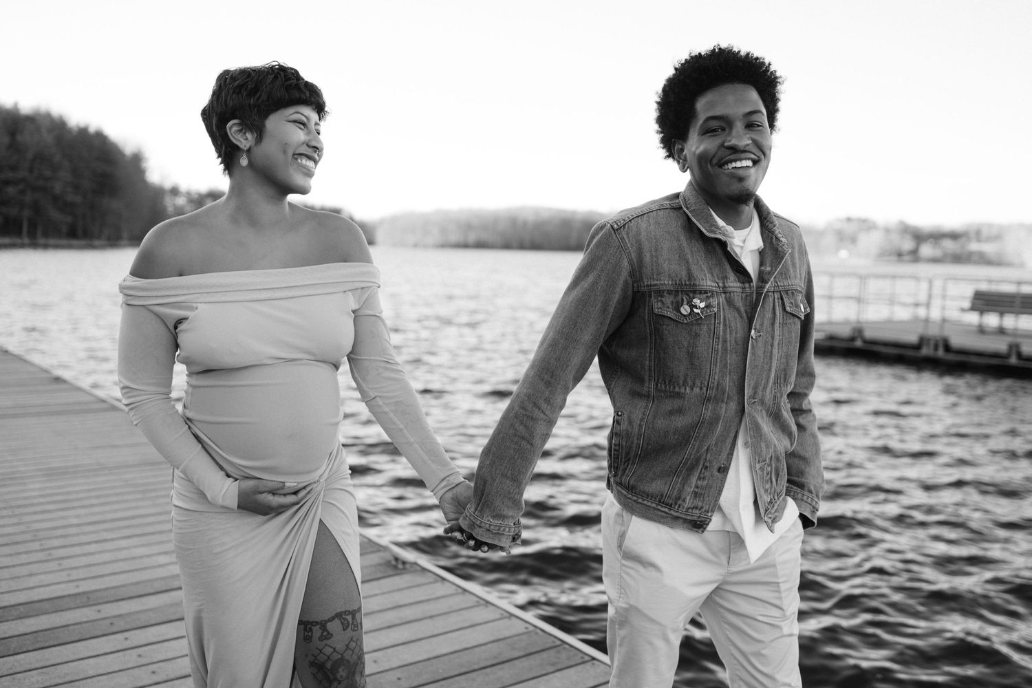 pregnant couple walks together on dock in eldersburg maryland