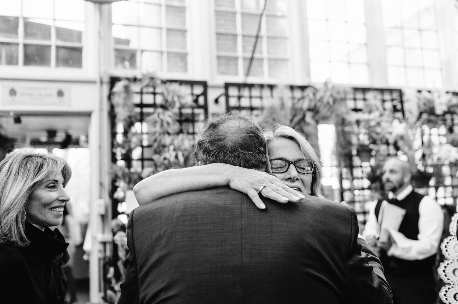 Black and white emotional moment captured during wedding celebration.