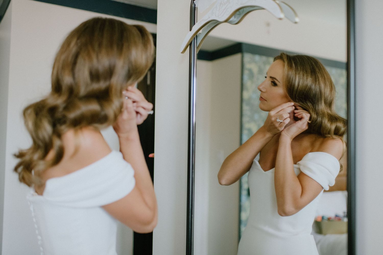 bride putting earings in