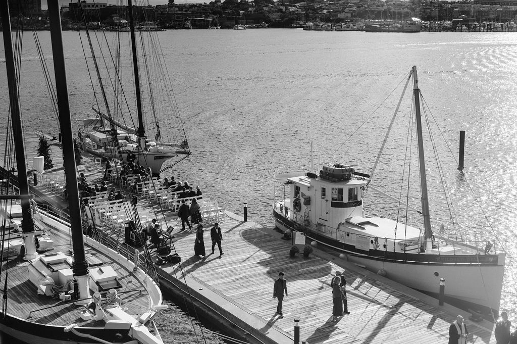 wedding ceremony on pier outside the frederick douglas maritime museum