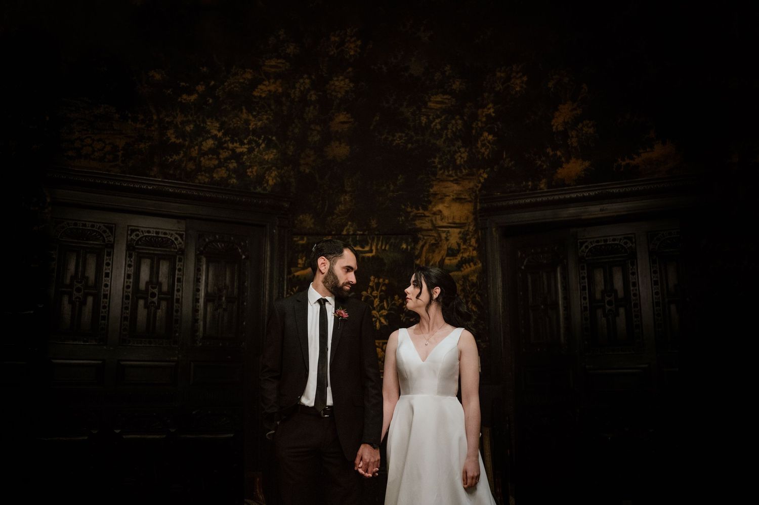 A romantic outdoor wedding photo session in a wooded area with natural lighting.