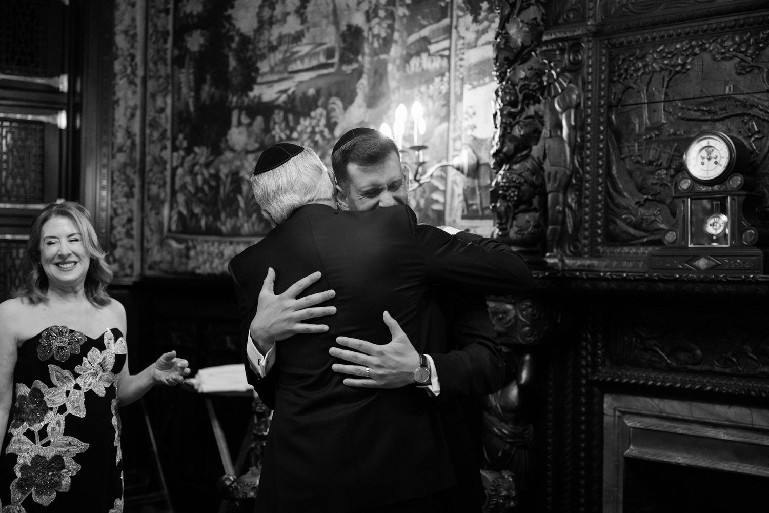 A black and white photo capturing an emotional embrace during a wedding celebration at a Baltimore engineers club wedding