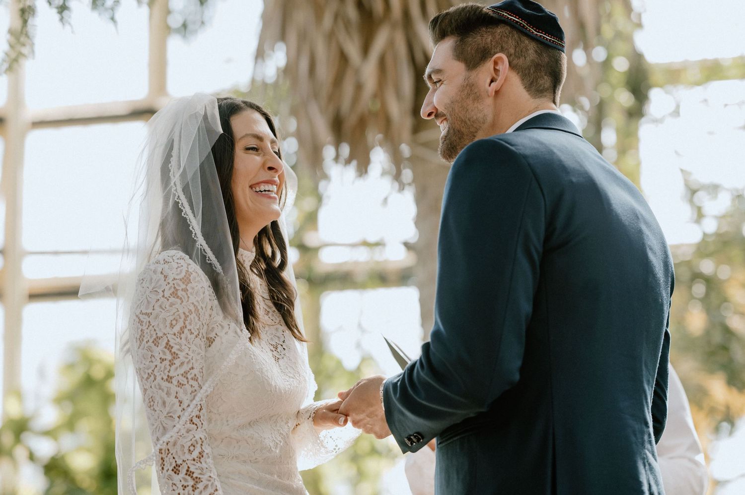 A couple shares an intimate moment during their outdoor wedding ceremony.