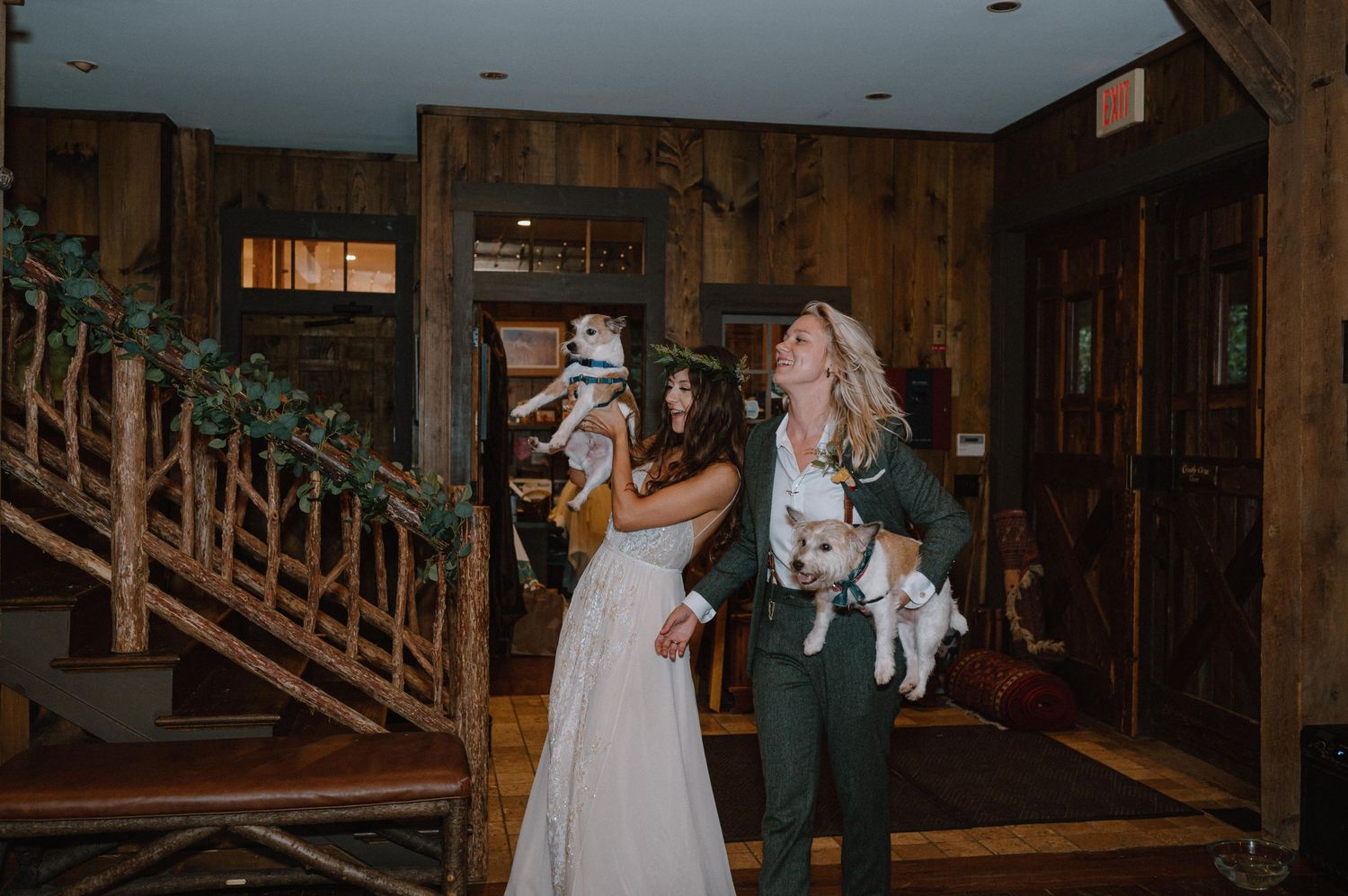 Wedding celebration in a rustic wooden lodge interior with guests enjoying the festivities.