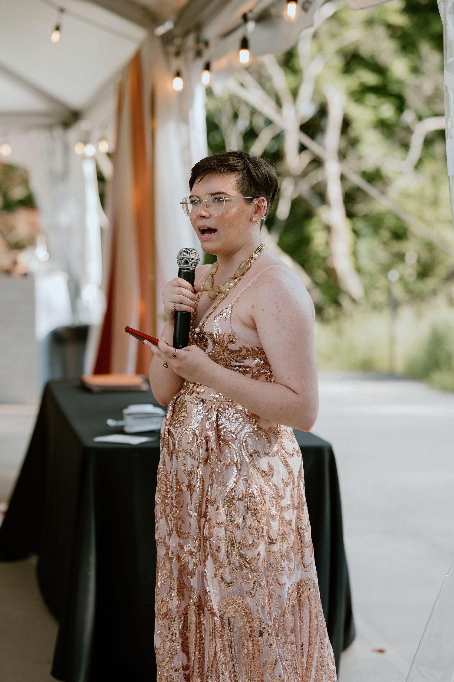 Wedding guest giving an emotional speech at reception.