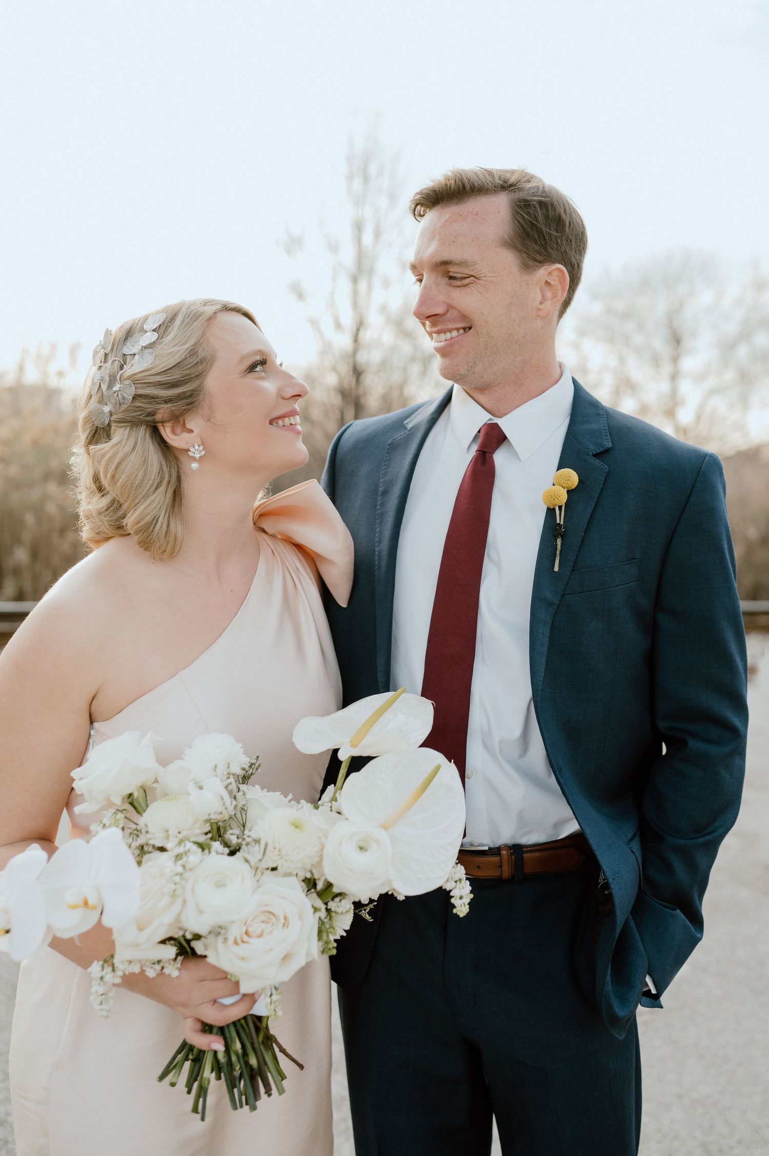 Happy couple sharing intimate moment outdoors during wedding photoshoot.