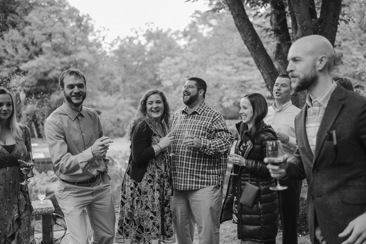 Wedding guests enjoying cocktail hour outdoors.