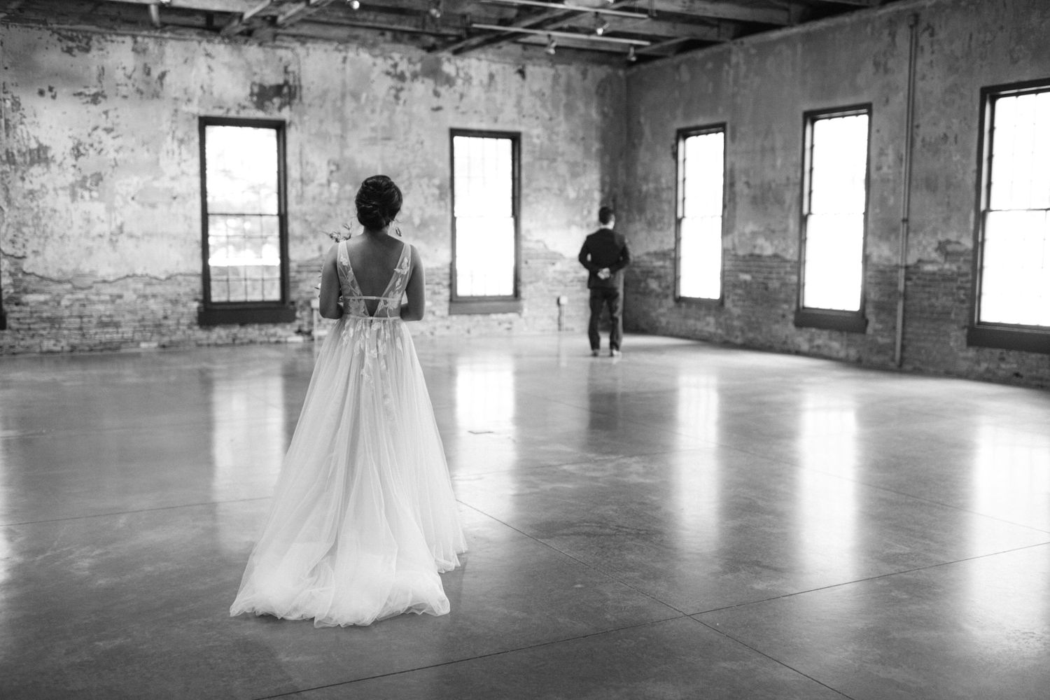 bride walks up behind groom
