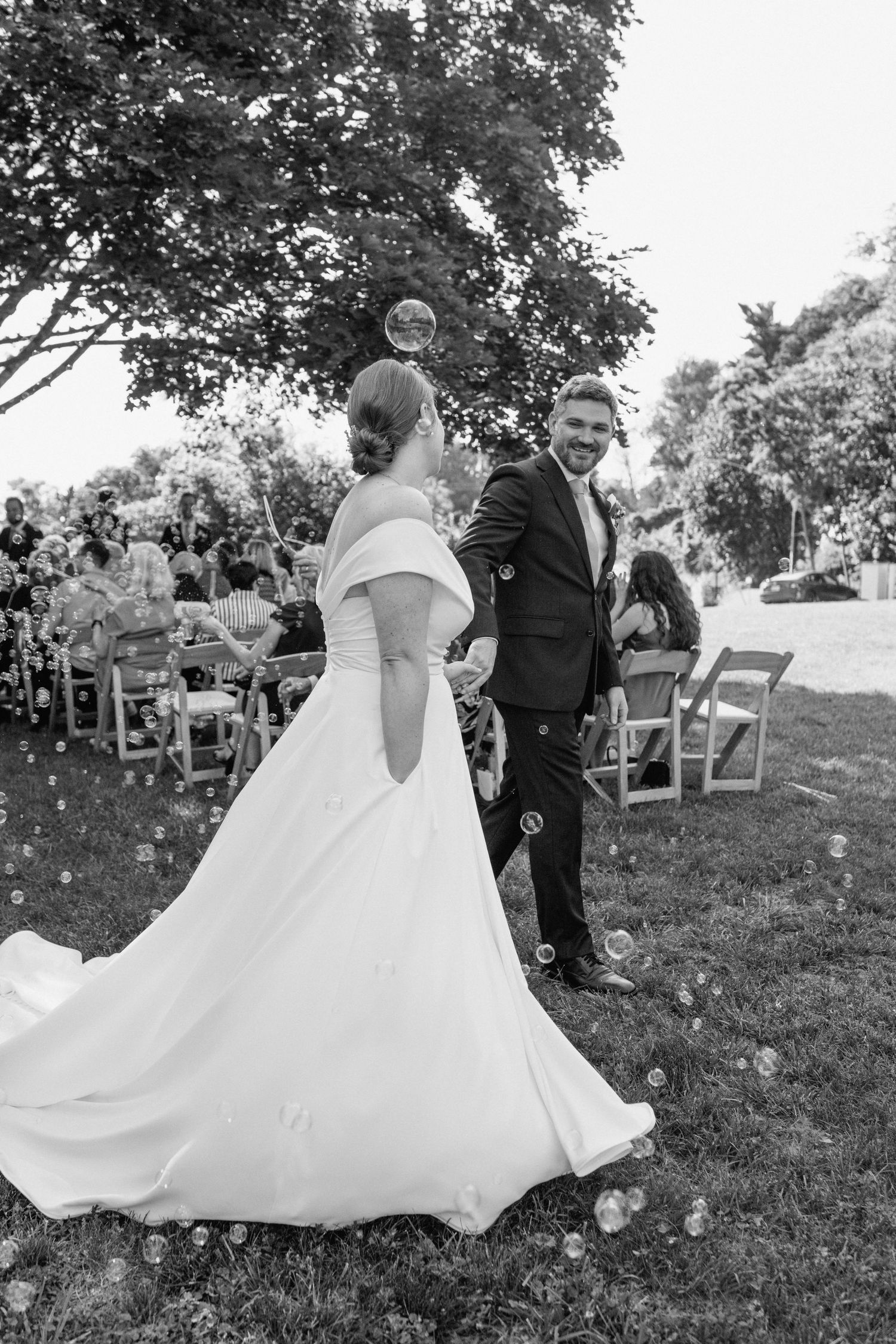 Black and white photo of a couple during their outdoor wedding ceremony.