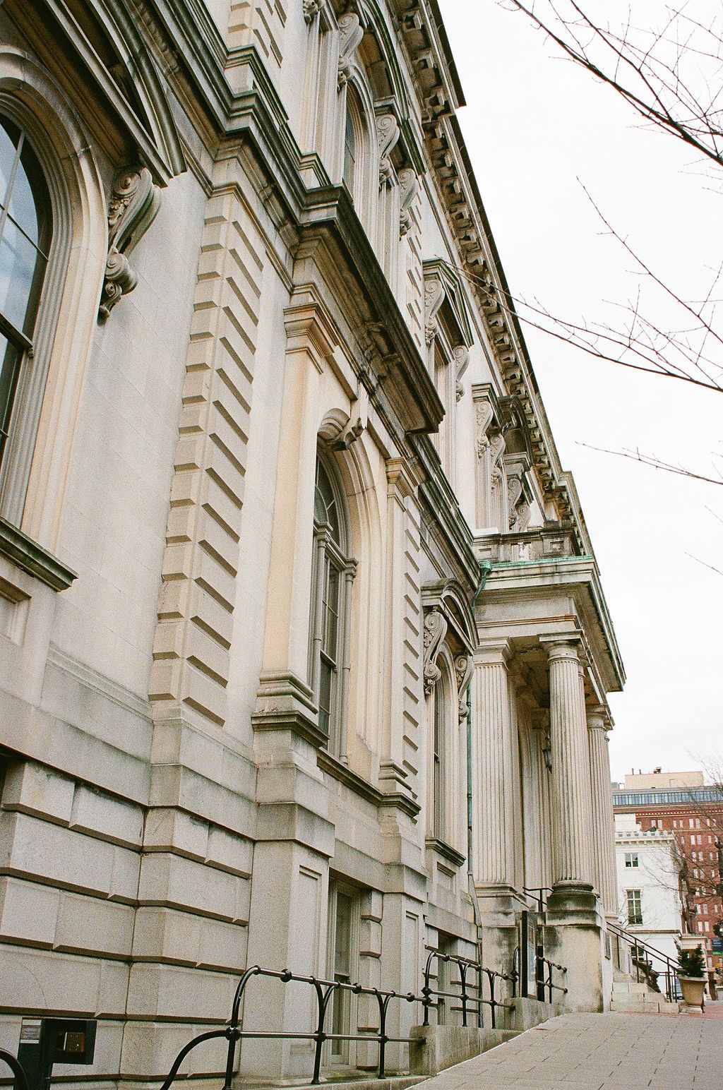 Classical stone building exterior with ornate architectural details and columns at George Peabody Library Wedding in Baltimore