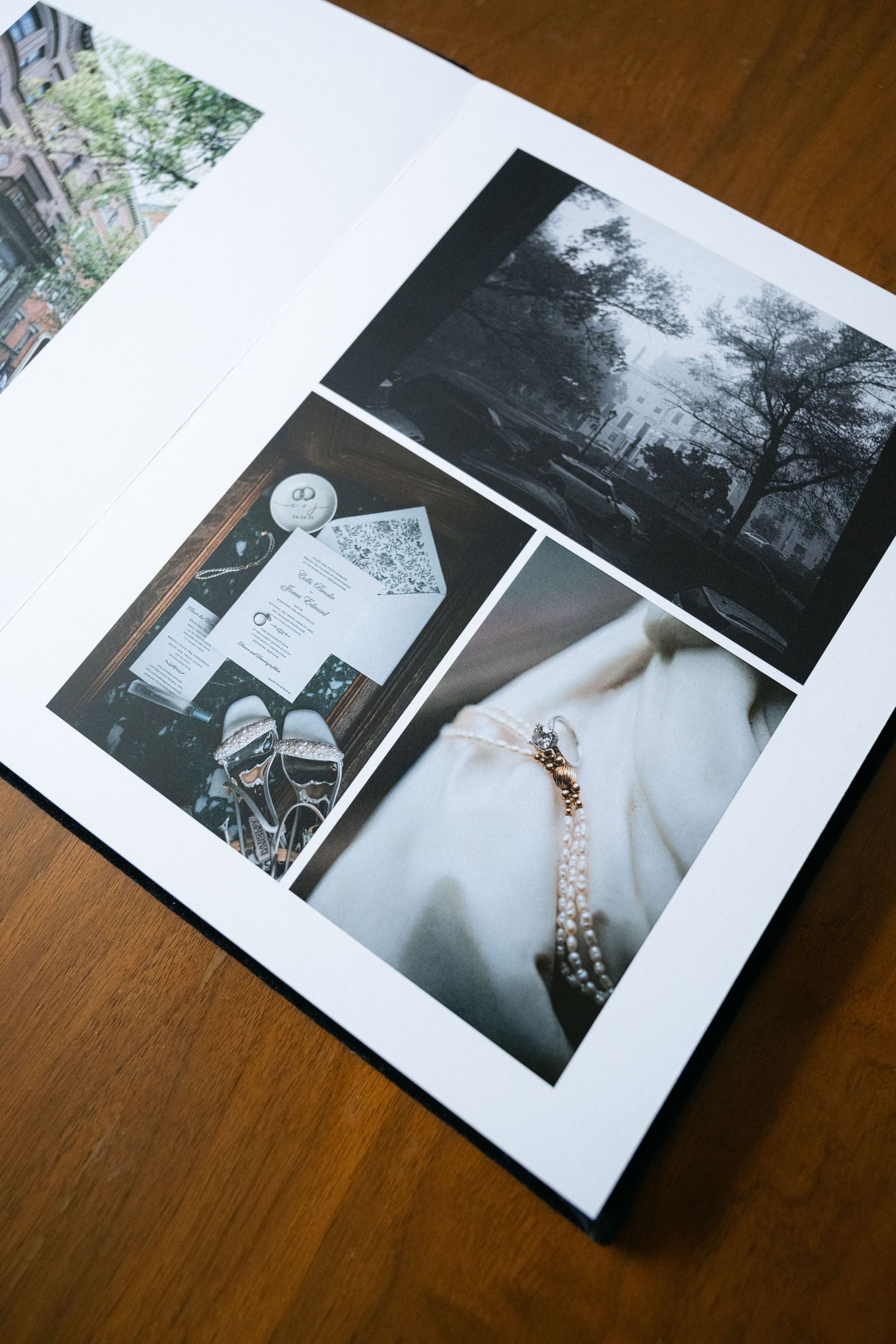 Wedding photo album pages displayed on a wooden table showing dress details.