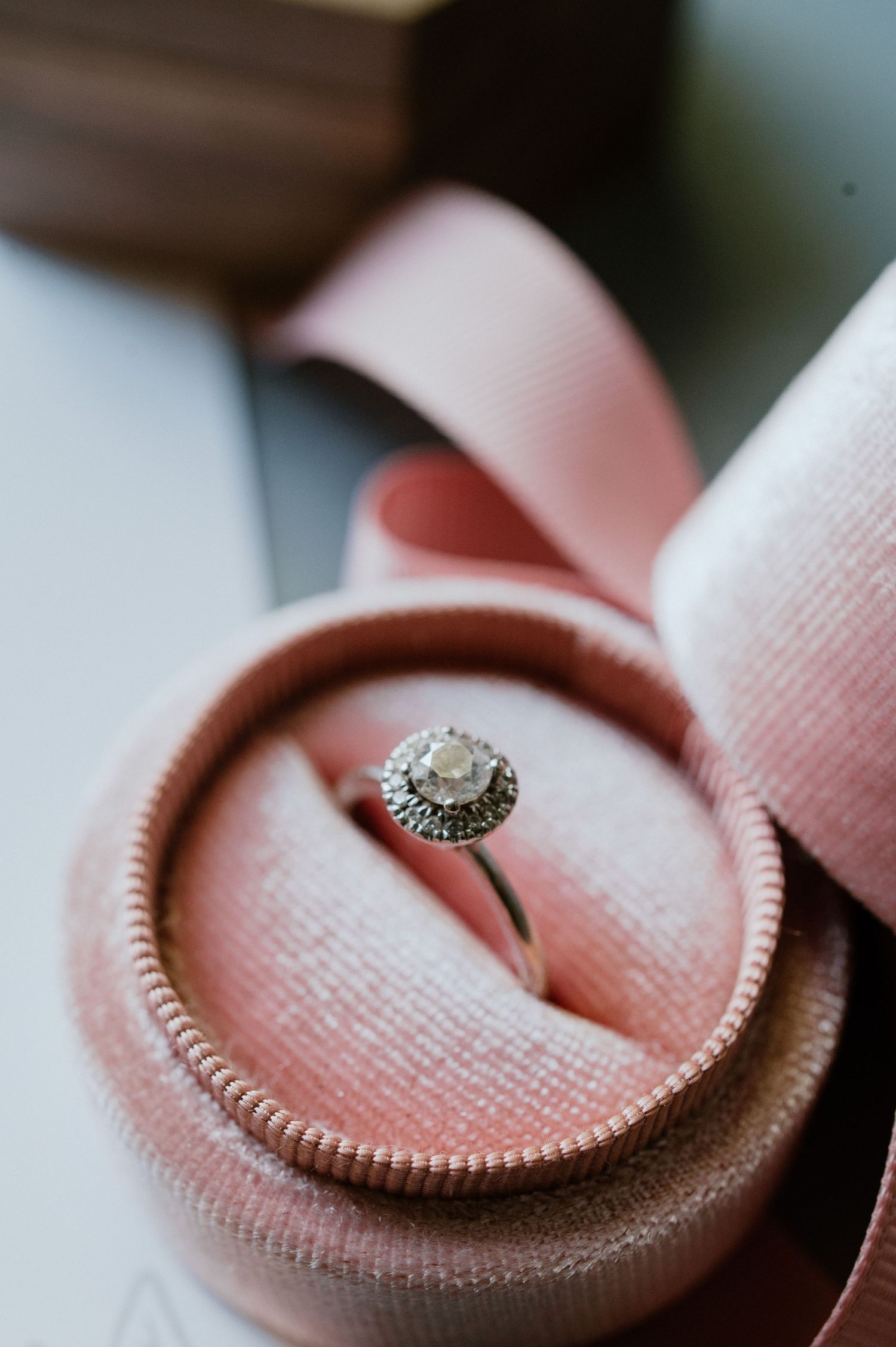 Vintage-style engagement ring in pink velvet ring box with delicate details.