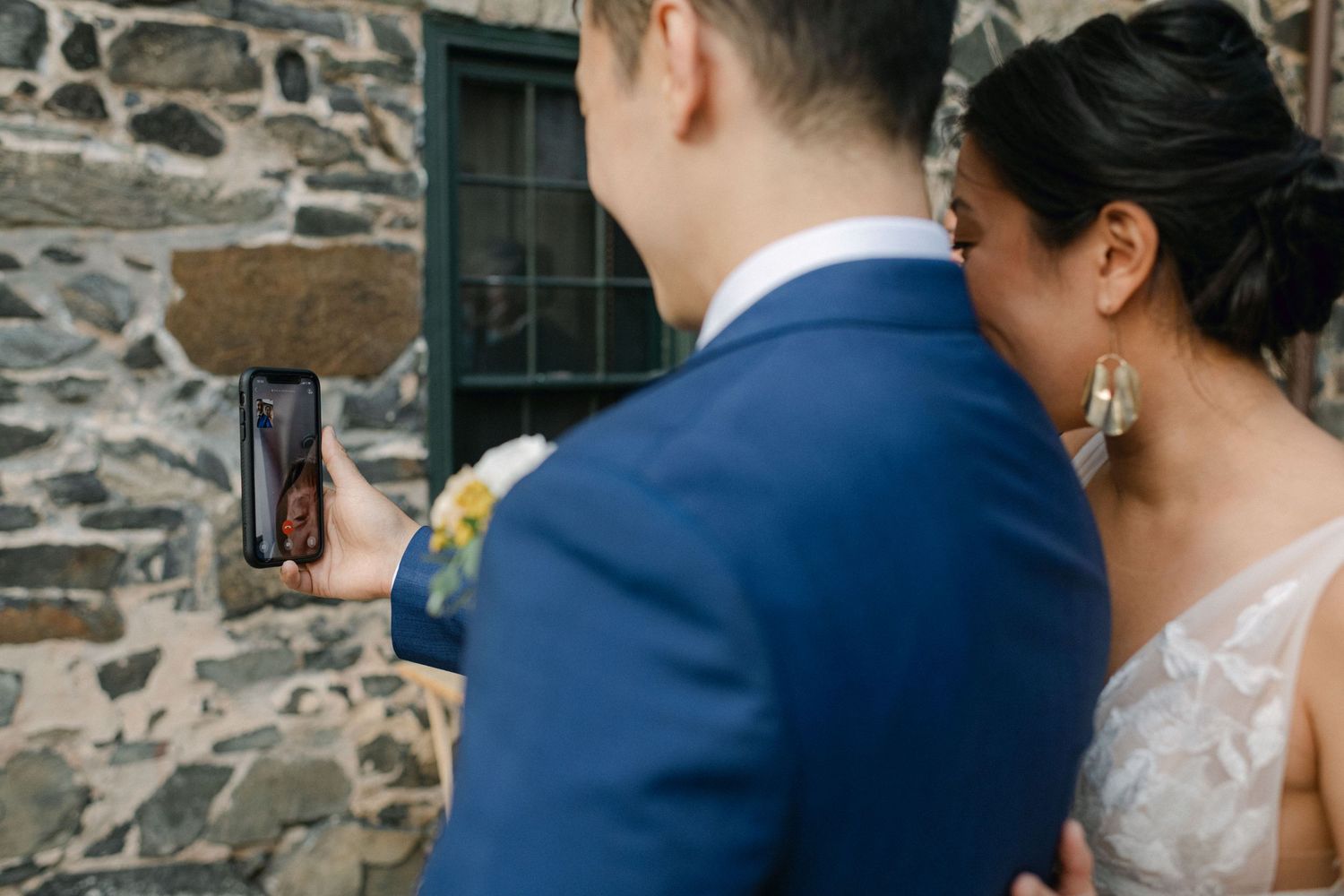 bride and groom talk to grandmother on video call