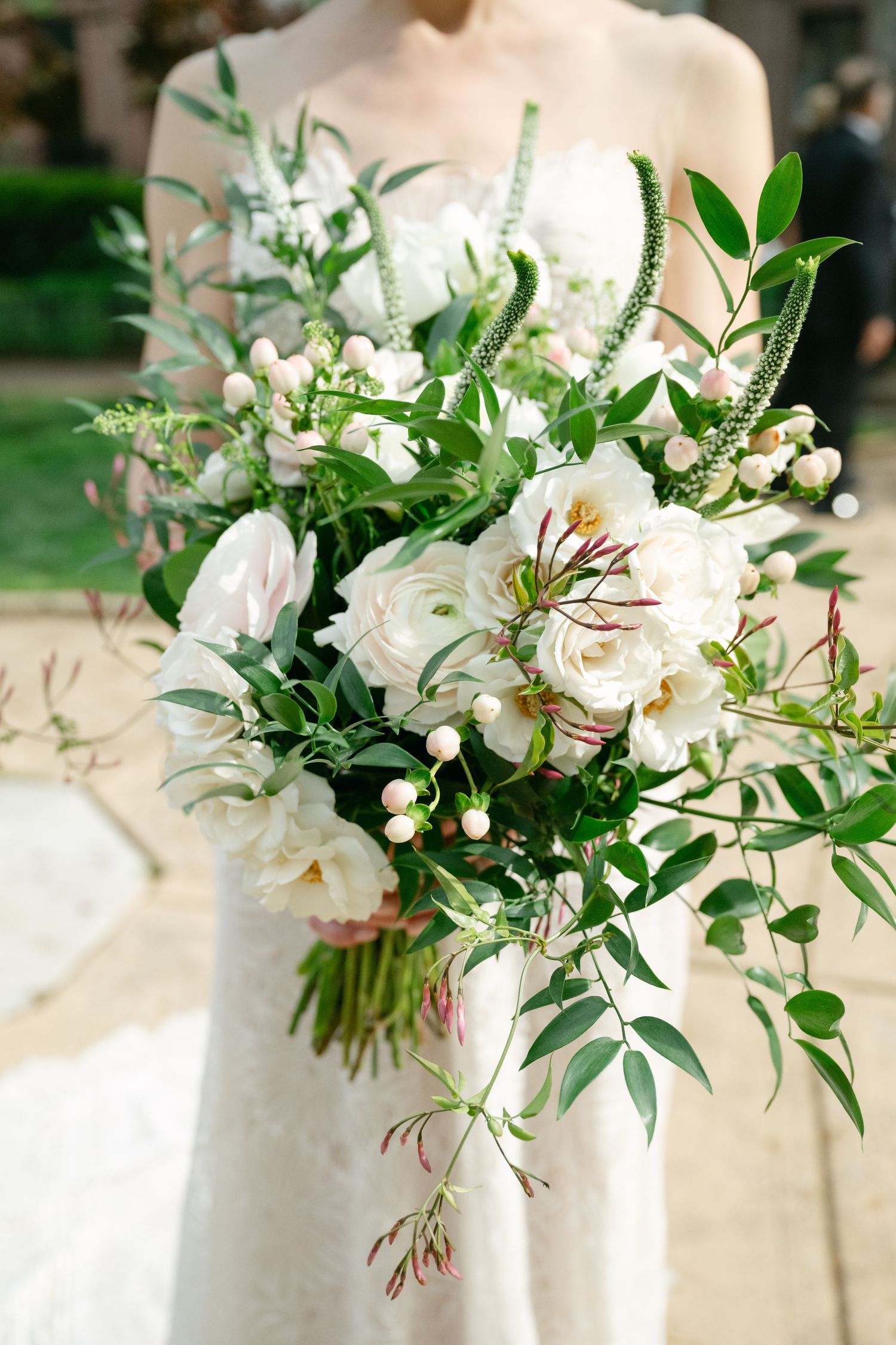 Elegant white and green wedding bouquet featuring roses and delicate foliage against a bridal gown at a Baltimore engineers club wedding