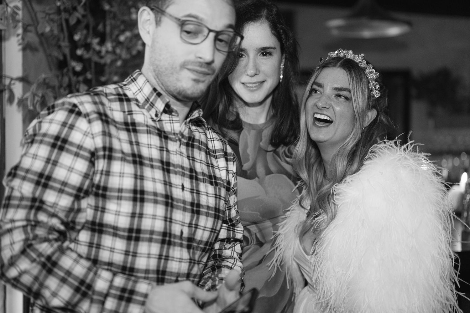 A candid black and white photo capturing joyful laughter at a celebration.
