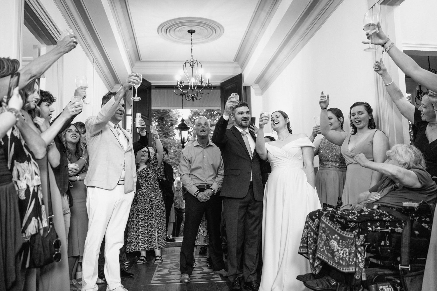 Wedding guests dancing and celebrating together on the dance floor during a reception party.