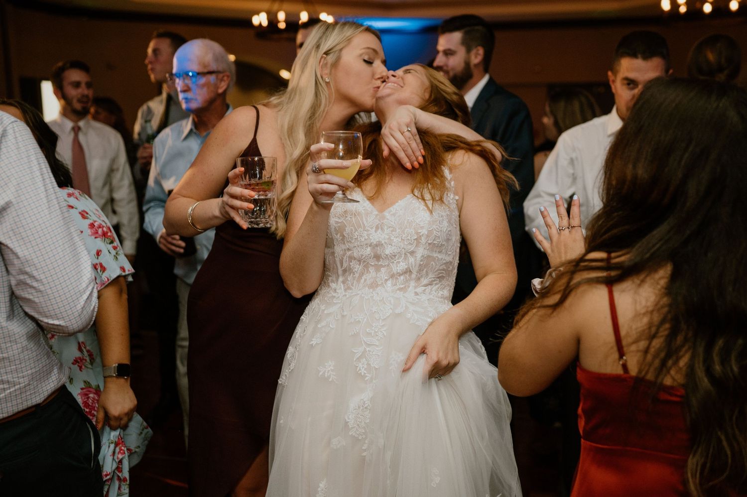 Wedding reception dance party with guests celebrating on the dance floor.
