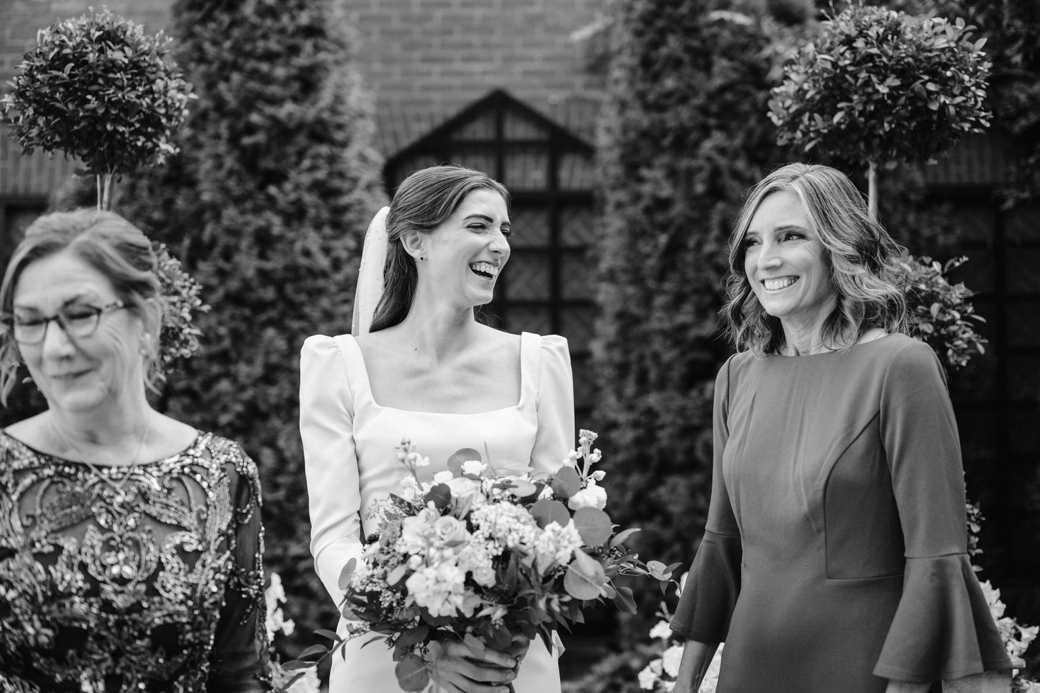 A candid moment of laughter and joy shared during wedding festivities.