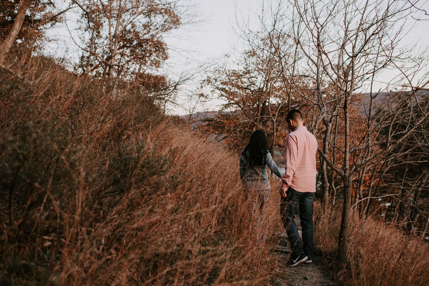 Walking along autumn hillside trail with scenic river views.