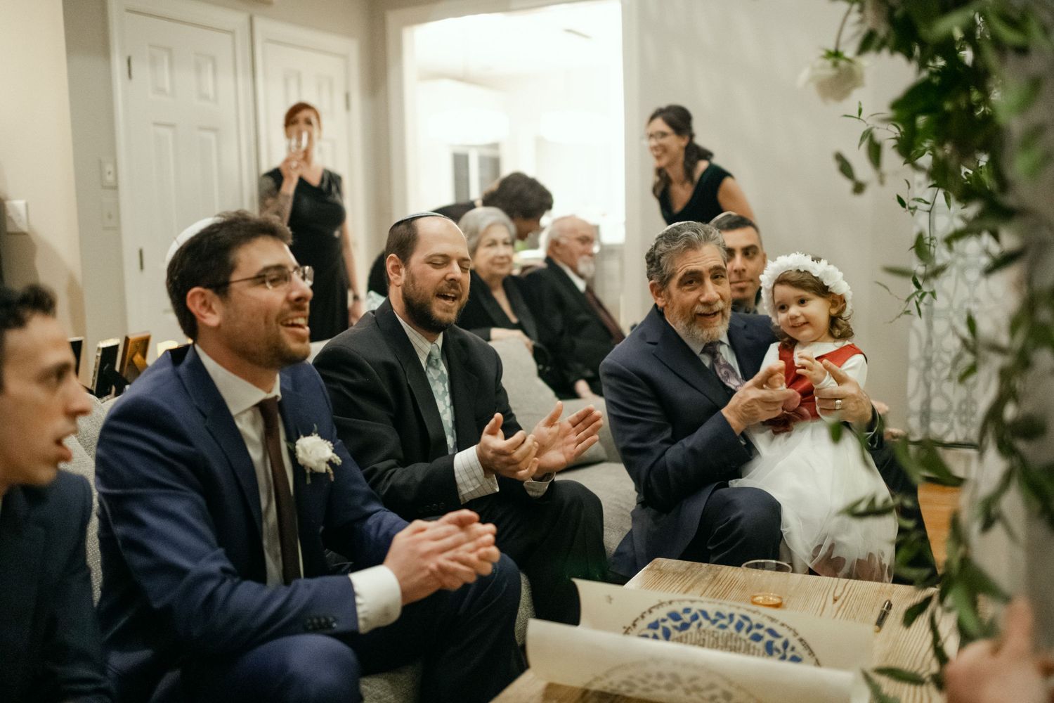 Wedding guests react with joy and laughter during a celebration.