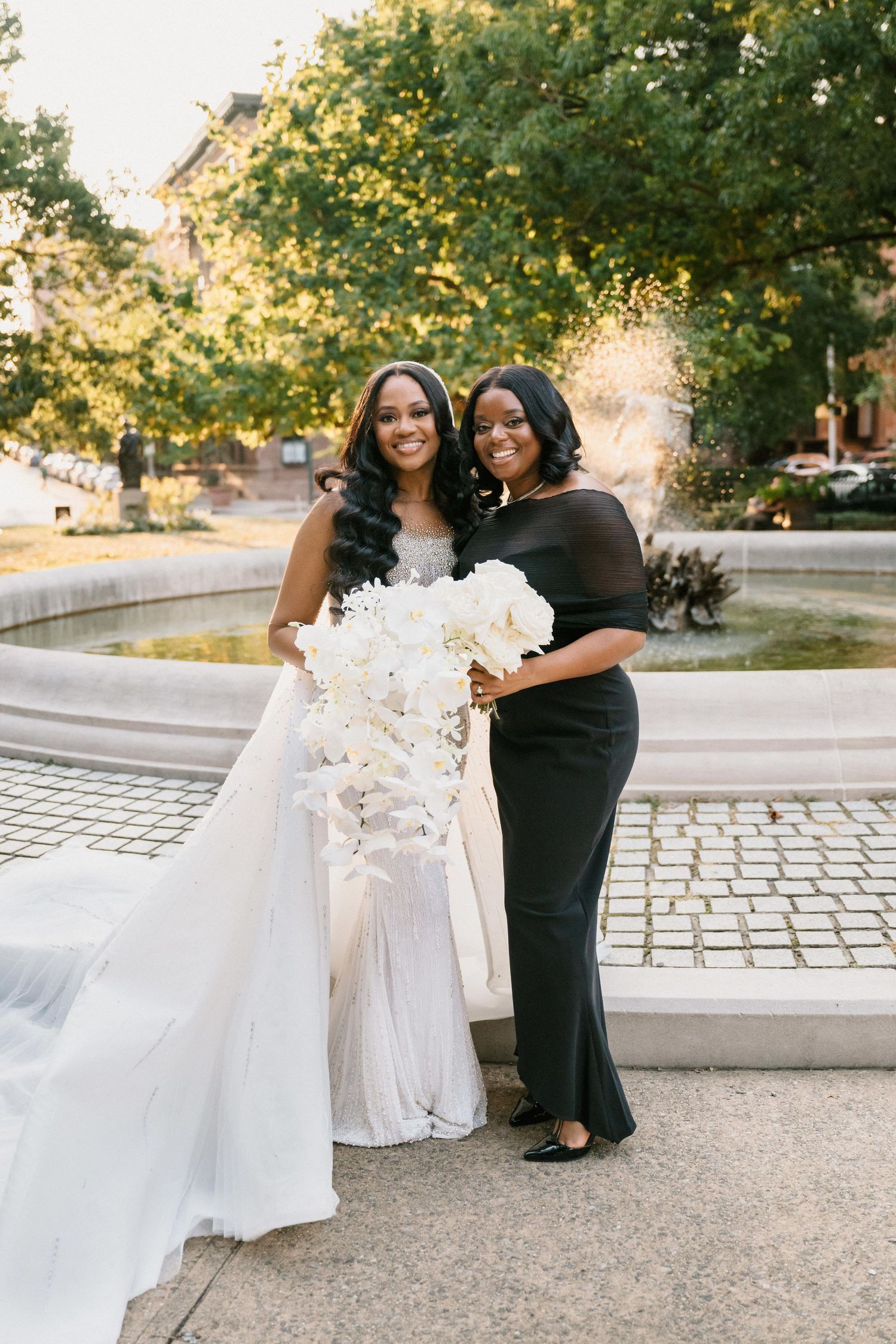 Wedding dress photos with flowing white fabric against autumn trees and stone pathways.