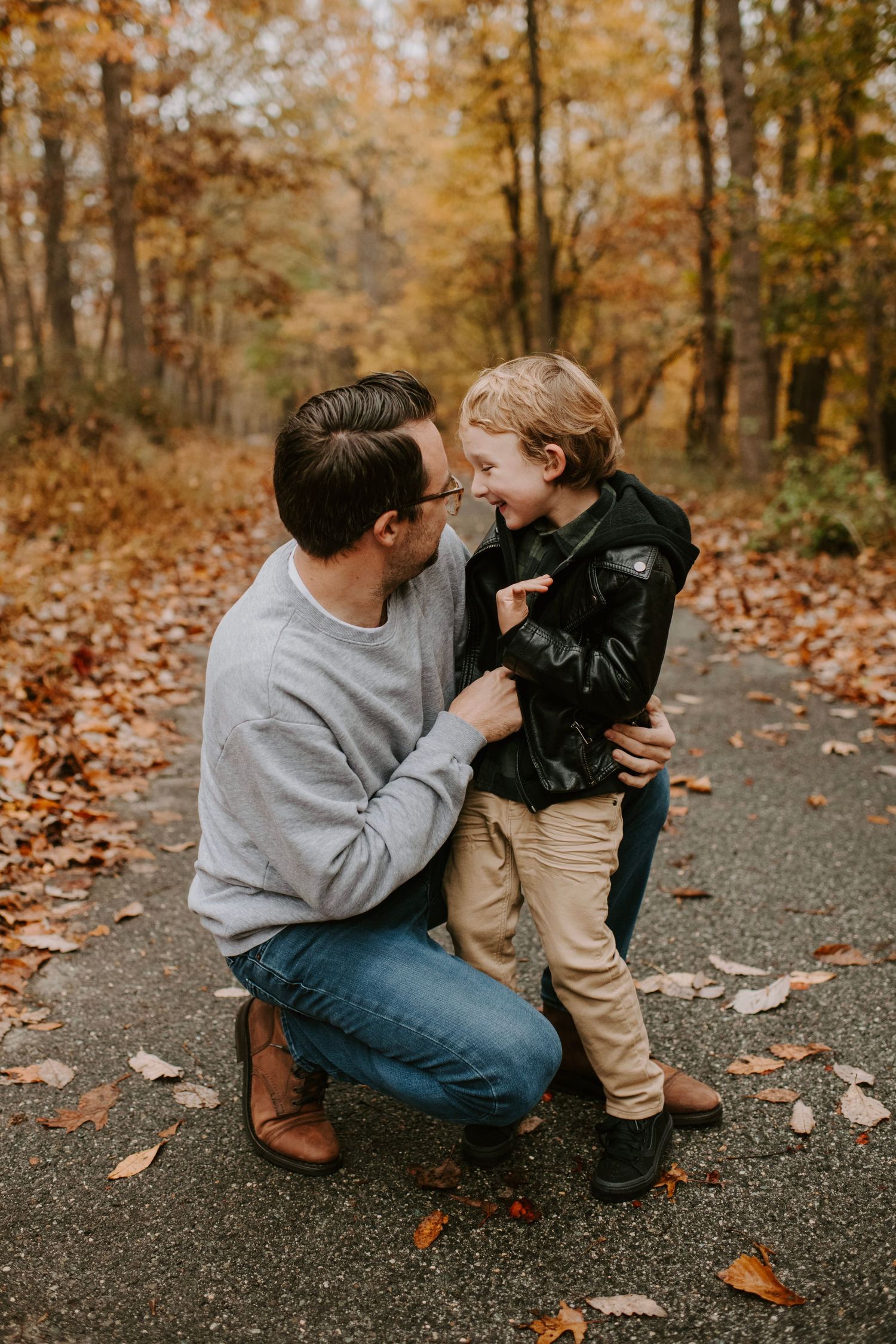 Sweet interaction on a wooded path surrounded by fall colors.