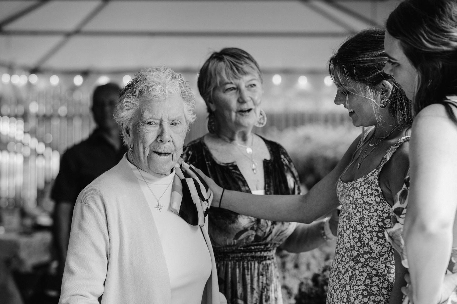Guests having an animated conversation during an indoor gathering.