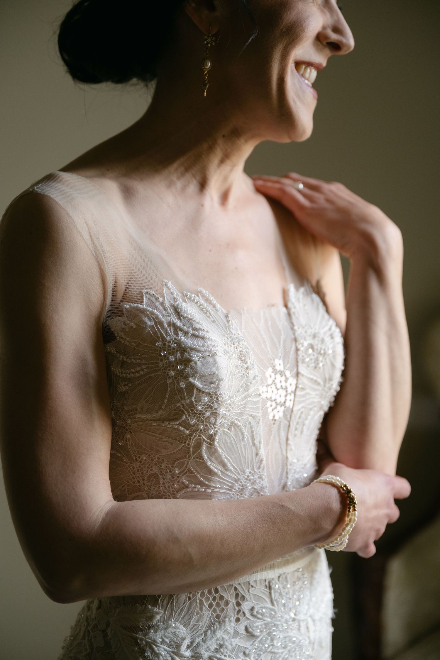 Close-up view of intricate lace bodice details on a strapless wedding gown.