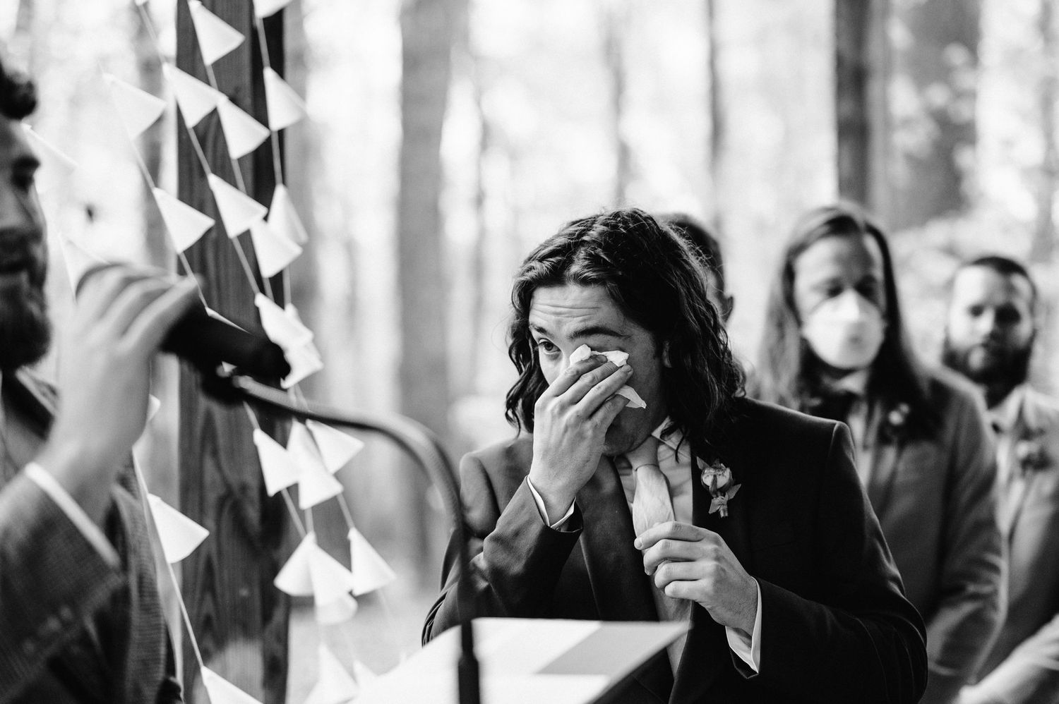 Black and white emotional moment during outdoor wedding ceremony.