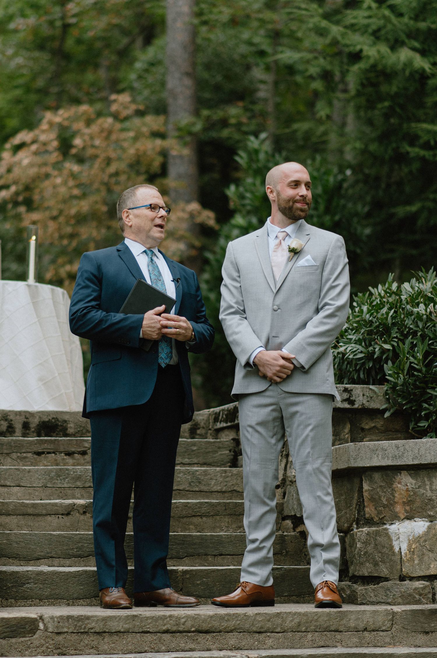 groom waits for bride at altar on strong mansion garden steps